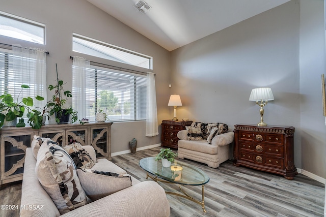 living room with vaulted ceiling and light hardwood / wood-style flooring