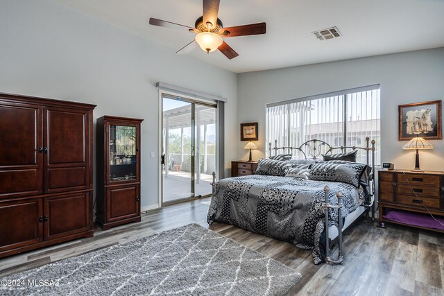 bedroom featuring ceiling fan, vaulted ceiling, and light hardwood / wood-style flooring