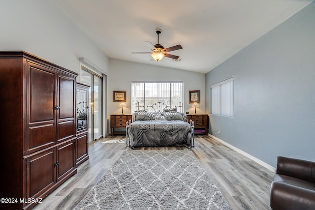 bedroom with lofted ceiling, light wood-style flooring, baseboards, and ceiling fan