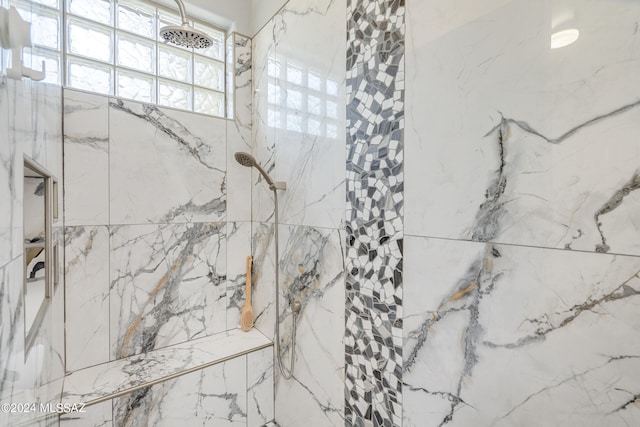 bathroom with a tile shower