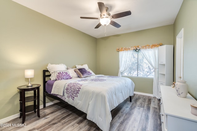 bedroom with wood-type flooring and ceiling fan