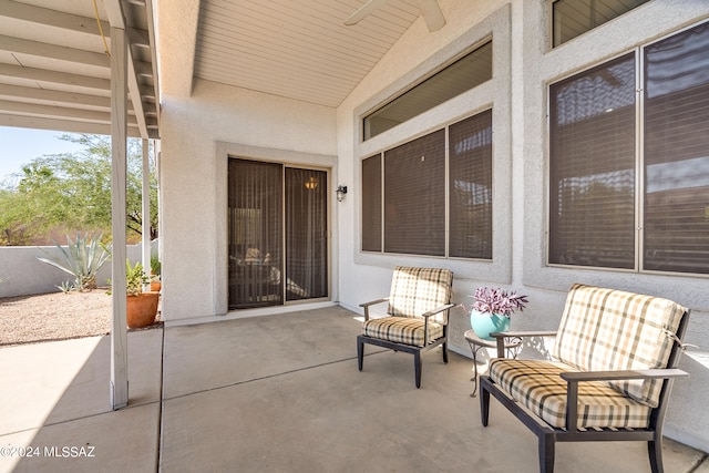 view of patio with ceiling fan and fence