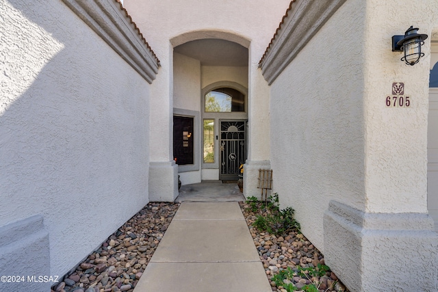 property entrance with stucco siding