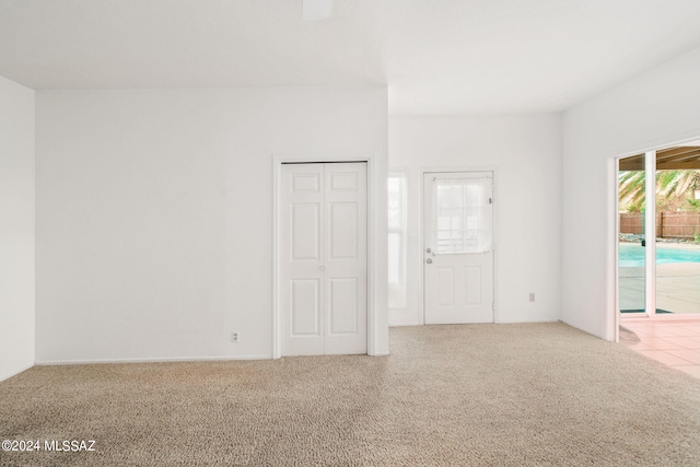 unfurnished room with light colored carpet