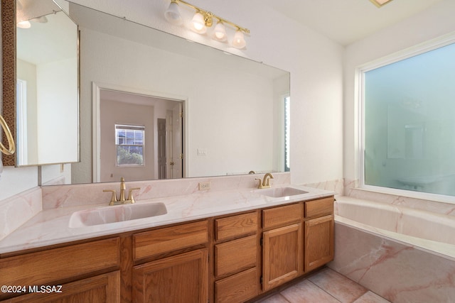 bathroom with vanity, tile patterned flooring, and a tub