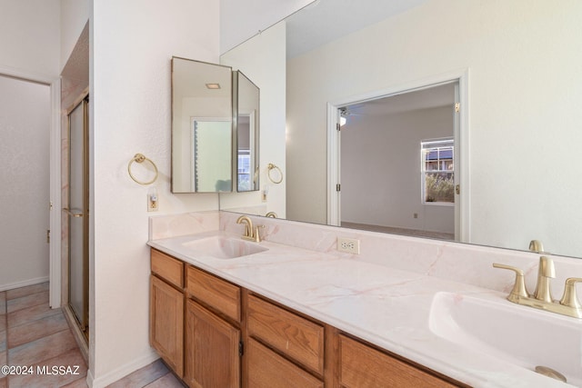 bathroom with walk in shower, tile patterned flooring, and vanity