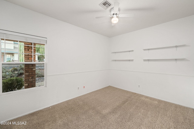 empty room featuring ceiling fan and carpet flooring