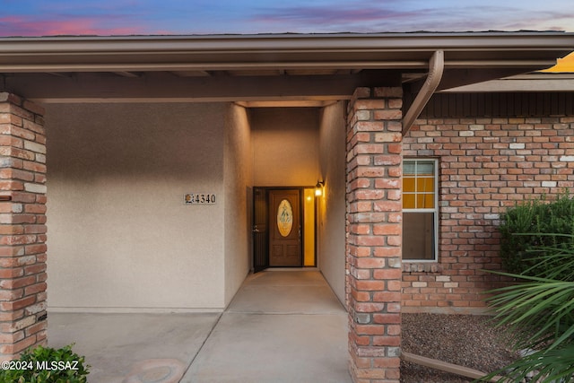 view of exterior entry at dusk