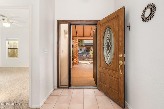 entryway featuring wooden ceiling, ceiling fan, and light colored carpet