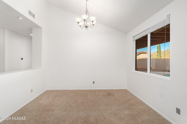 spare room featuring carpet flooring, vaulted ceiling, and a notable chandelier