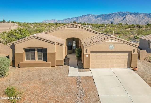 view of front facade with a garage and a mountain view