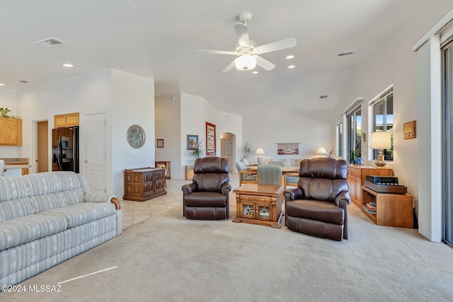 living room with light carpet, ceiling fan, and lofted ceiling