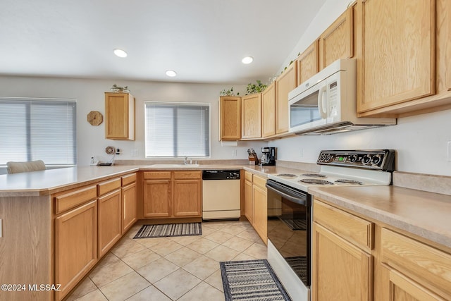 kitchen with kitchen peninsula, sink, white appliances, light tile patterned floors, and light brown cabinetry