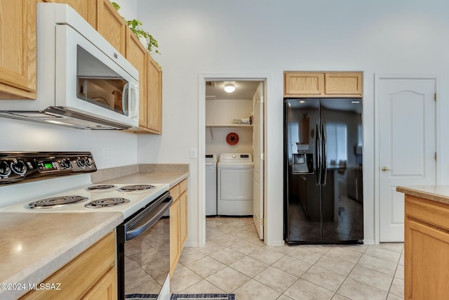 kitchen with washer and clothes dryer, light brown cabinets, light tile patterned floors, and black appliances