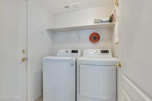 clothes washing area with washing machine and clothes dryer