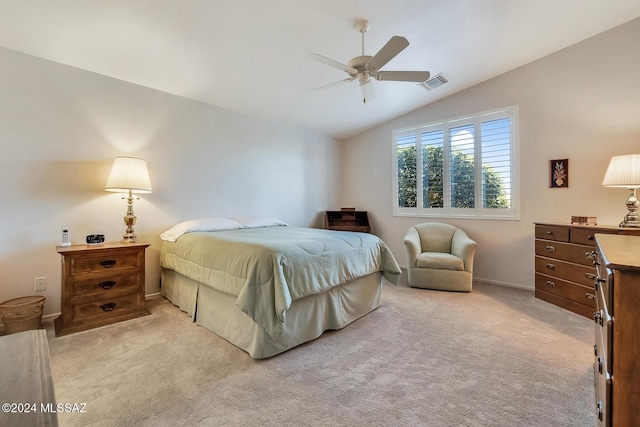 bedroom with ceiling fan, lofted ceiling, and light colored carpet