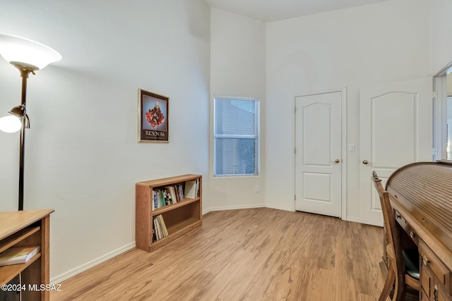 home office with light hardwood / wood-style floors