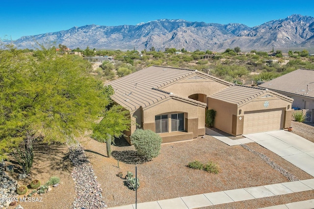 view of front of house with a mountain view and a garage