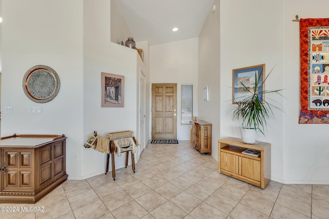 tiled entryway featuring a high ceiling