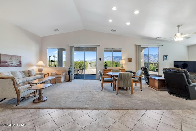 dining area featuring ceiling fan, light tile patterned floors, and vaulted ceiling