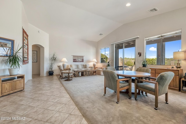 tiled dining area with lofted ceiling