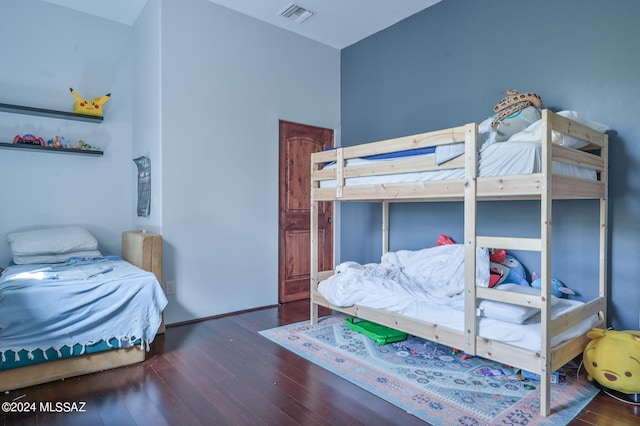 bedroom with dark hardwood / wood-style floors