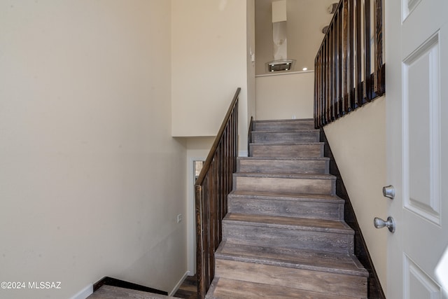 stairs with wood-type flooring