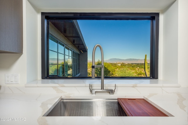 kitchen with a mountain view, sink, and tasteful backsplash