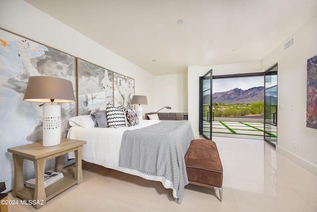 bedroom with a mountain view and access to exterior