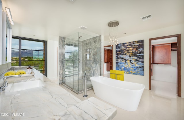 bathroom with shower with separate bathtub, sink, and a notable chandelier