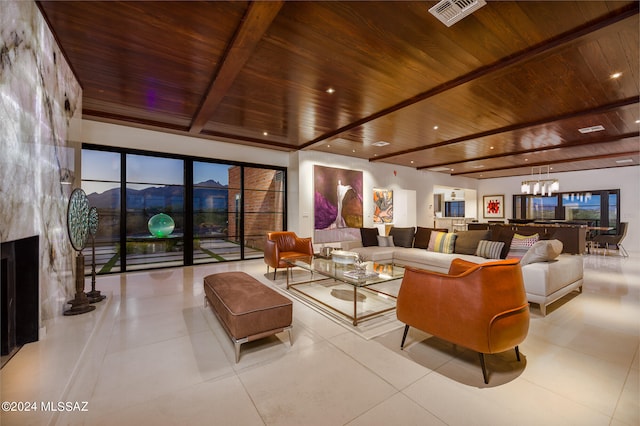 tiled living room with wood ceiling, an inviting chandelier, beamed ceiling, and a fireplace