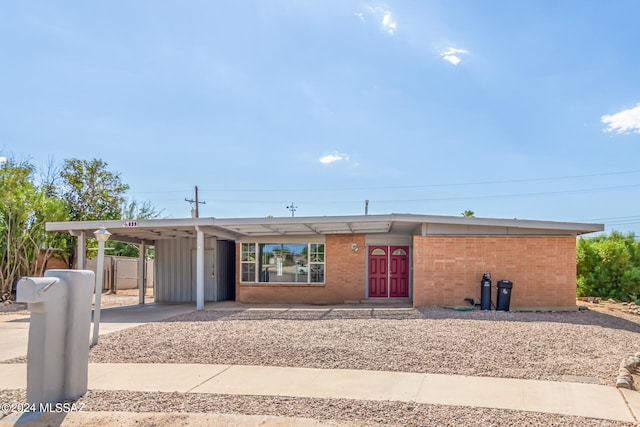 ranch-style house featuring a carport