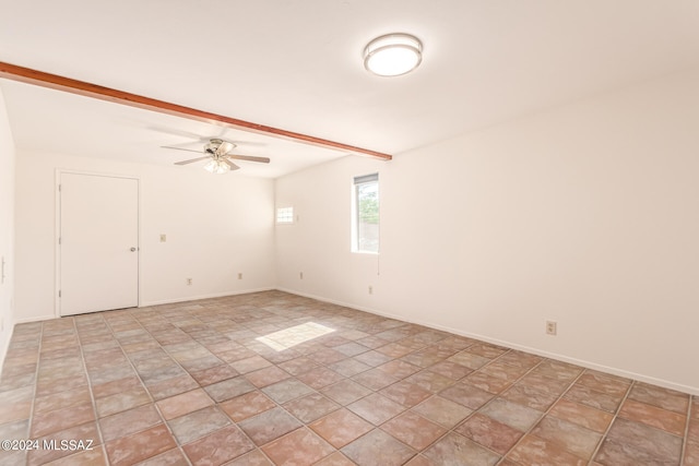 tiled spare room featuring beam ceiling and ceiling fan