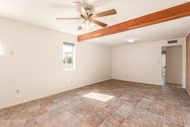 empty room featuring ceiling fan, beamed ceiling, and light tile patterned floors