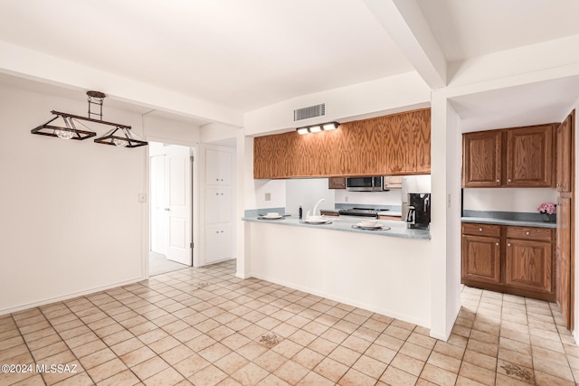 kitchen featuring sink, pendant lighting, and stainless steel appliances