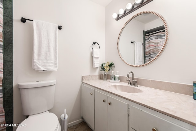 bathroom with tile patterned floors, vanity, and toilet