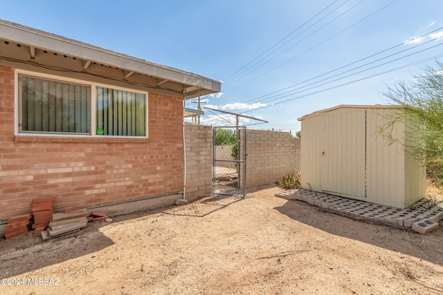 view of side of home featuring a shed