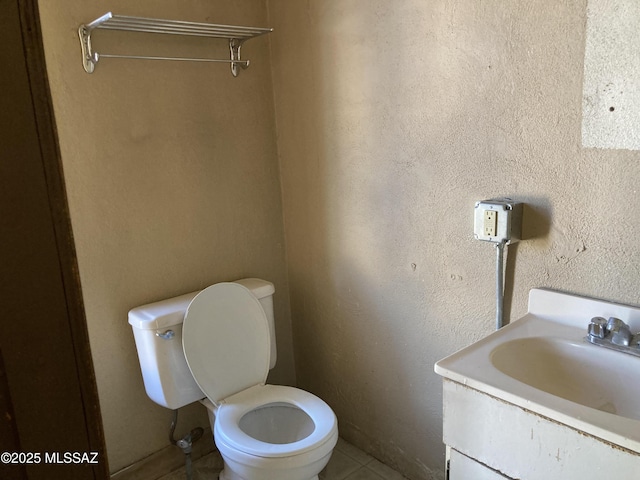 bathroom with tile patterned floors, vanity, and toilet