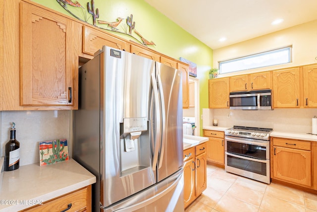 kitchen with appliances with stainless steel finishes and light tile patterned flooring