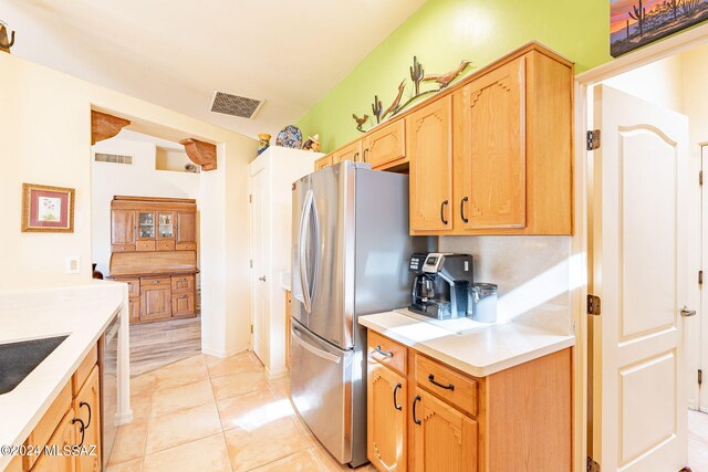 kitchen with stainless steel fridge and light tile patterned floors