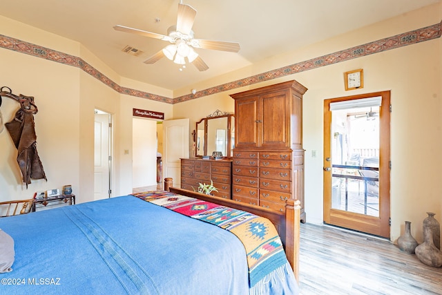 bedroom with light hardwood / wood-style floors and ceiling fan