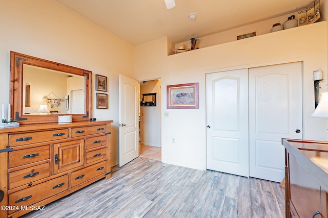 bedroom with light hardwood / wood-style flooring and a closet