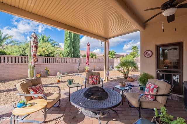 view of patio with a fire pit and ceiling fan