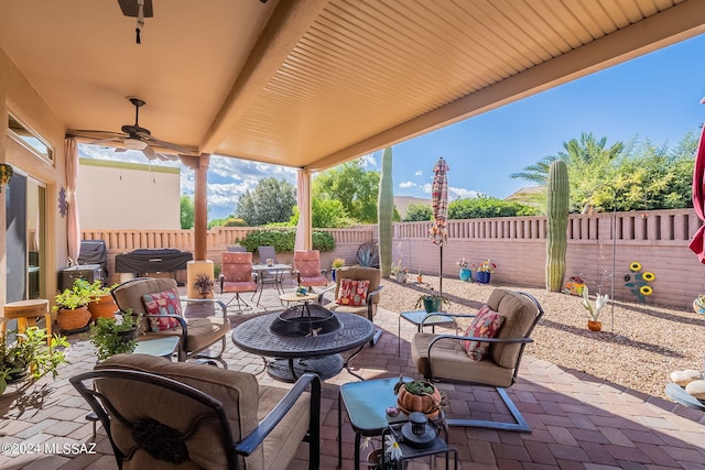 view of patio / terrace featuring ceiling fan and a fire pit