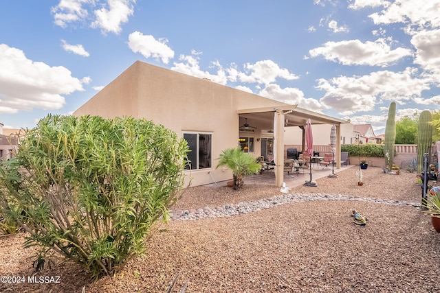 rear view of house with a patio area and ceiling fan