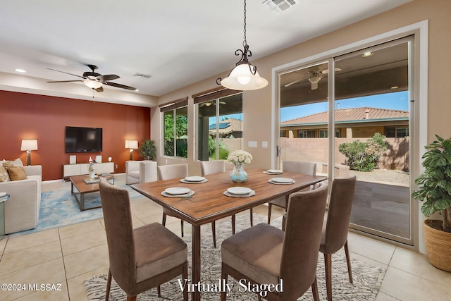 dining space featuring ceiling fan and light tile patterned floors