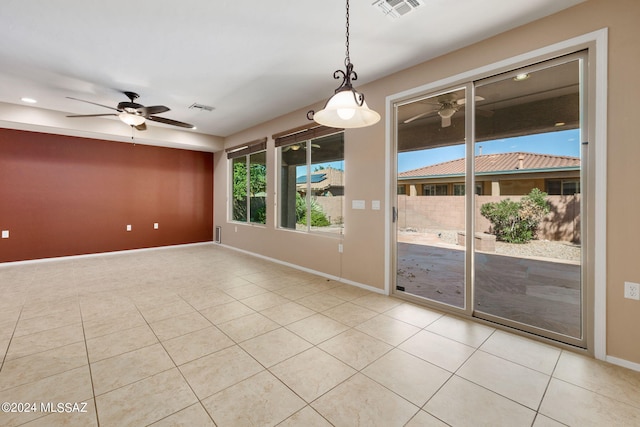 spare room featuring ceiling fan and light tile patterned floors