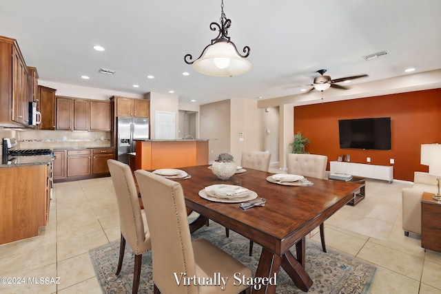 dining room with light tile patterned floors and ceiling fan