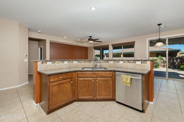 kitchen with ceiling fan, a kitchen island with sink, sink, and stainless steel dishwasher