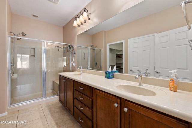 bathroom with tile patterned floors, an enclosed shower, and vanity